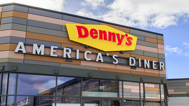 A Denny's location exterior with blue sky and clouds