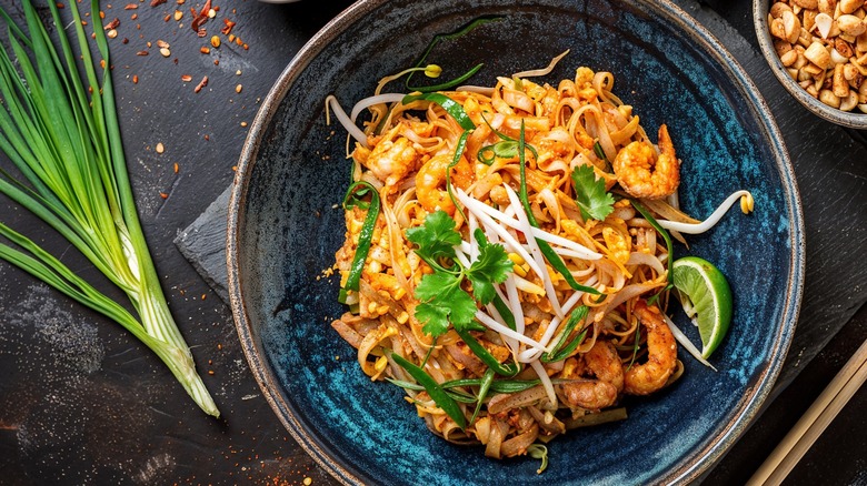 Pad Thai served on a dark blue plate