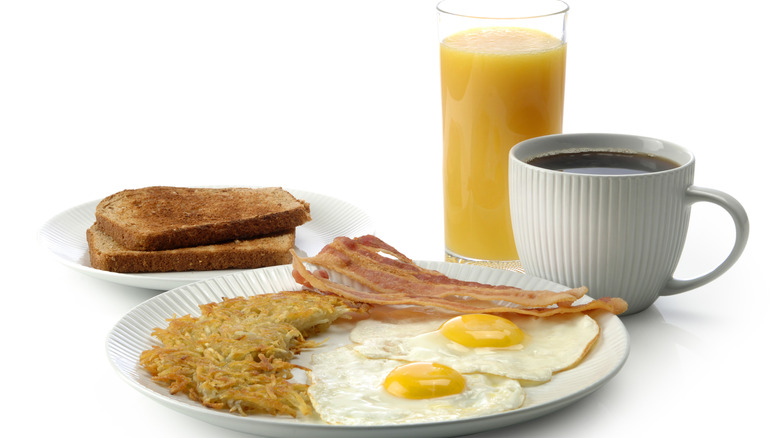 bacon, eggs, hashbrowns, toast, coffee, and orange juice