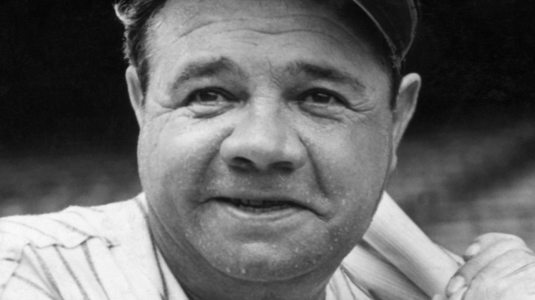 Babe Ruth on the field holding a baseball bat