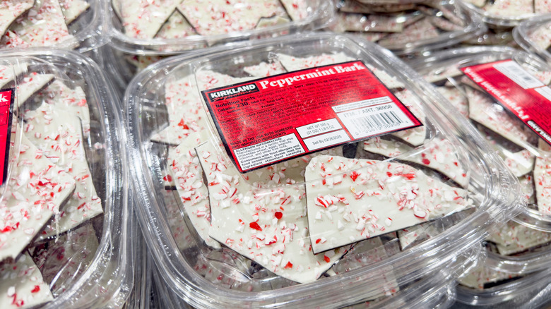 Containers of Kirkland Peppermint bark are stacked on a table