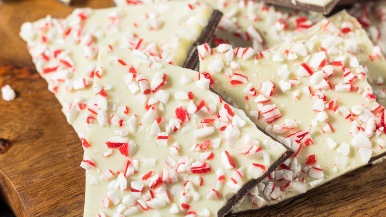 Pieces of homemade holiday peppermint bark sit on a table