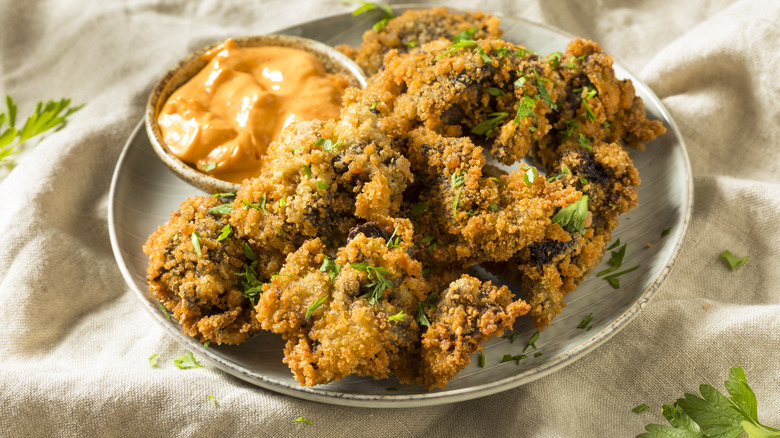 Breaded and fried chicken livers with orange sauce