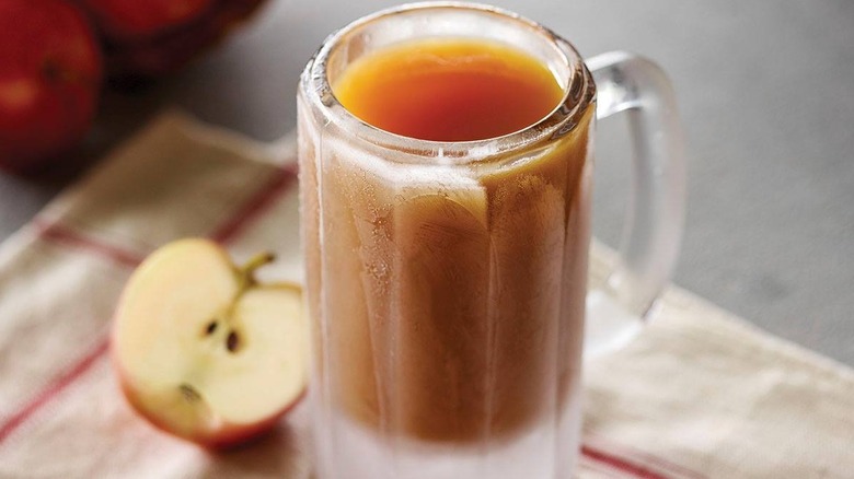 Frozen mug apple cider on table