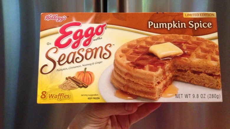 Hand holding box of Eggo Pumpkin Spice Waffles