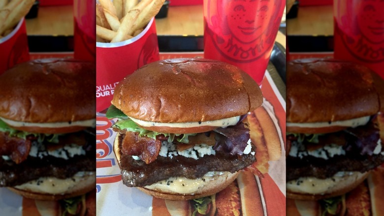 Burger with bacon, cheese, and salad on a Wendy's tray