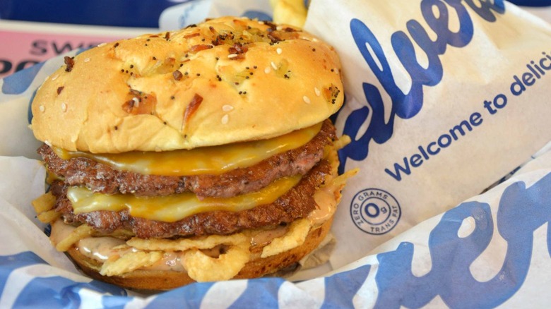 Burger with two beef patties and melted cheese on Culver's packaging