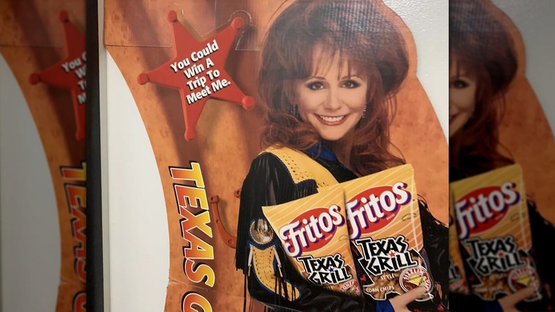 Reba McEntire happily holding a bag of Texas Grill Style Fritos