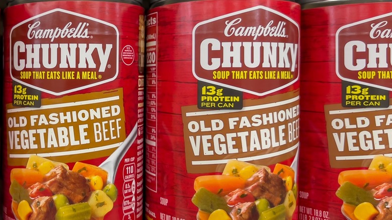 Cans of Campbell's Chunky old fashioned vegetable beef soup on store shelf