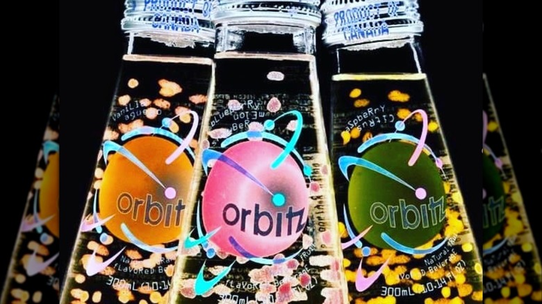 Bottles of Orbitz Soda on black background