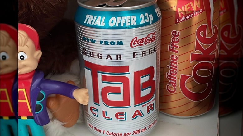 Can of Tab Clear beside Alvin doll