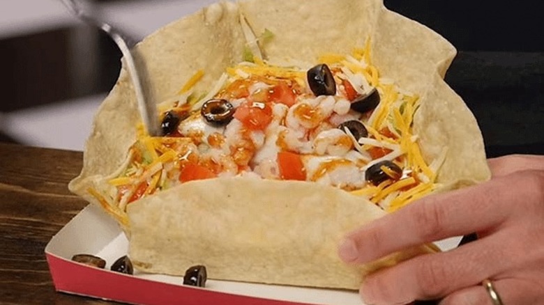 Hand holding Seafood Salad from Taco Bell