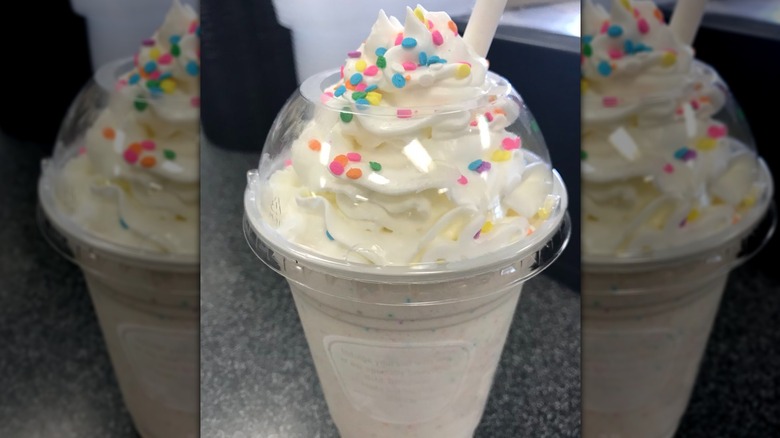 Birthday Cake Smoothie in plastic cup with straw