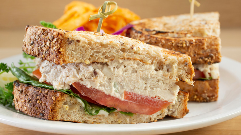 Tuna salad sandwich on wheat with tomato and lettuce