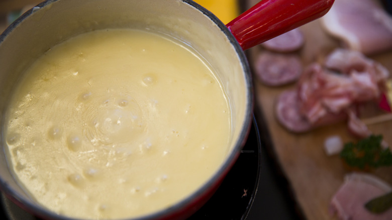 ground beef frying in a pan with spatula