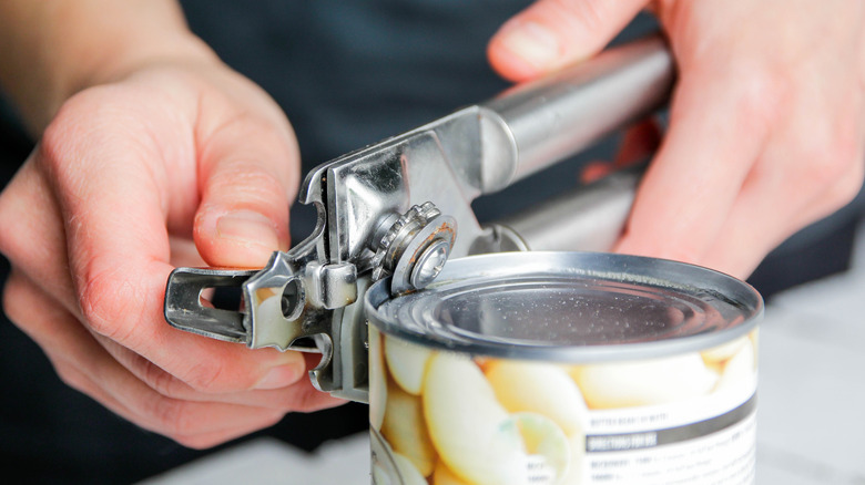 man opening canned food