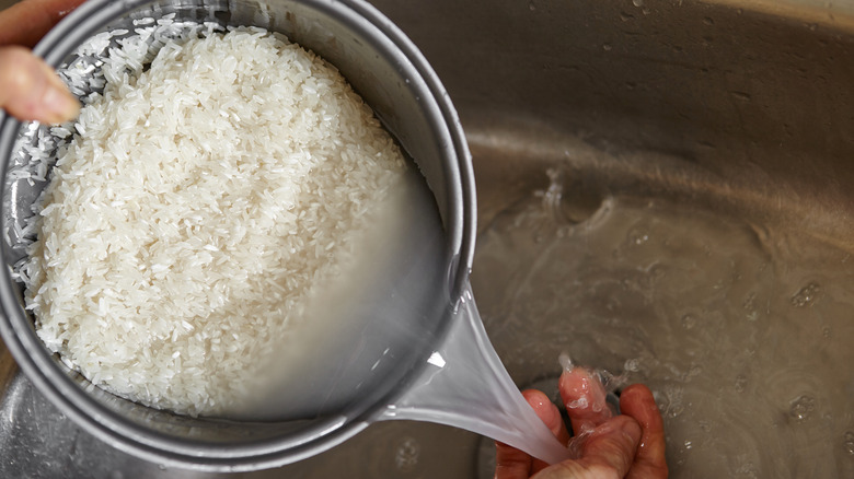 Rice being rinsed in pot