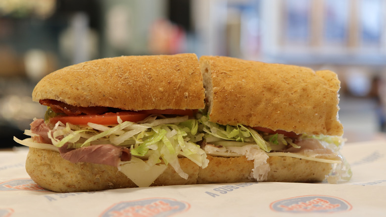 A Jersey Mike's sub sitting on wrapper paper with the logo