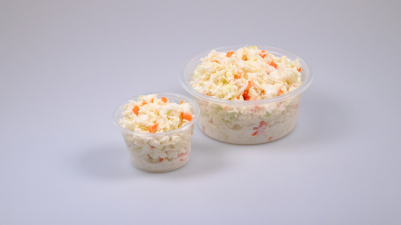 Two containers filled with coleslaw.