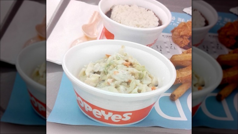 Popeyes coleslaw served in a small tub.