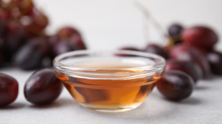 a small bowl of red wine vinegar with grapes