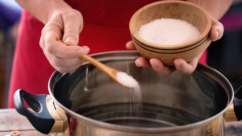 Salt added to pot of water