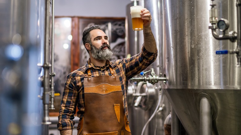 Person examining a fresh beer