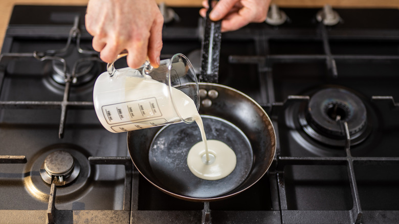 Pouring cream onto hot pan