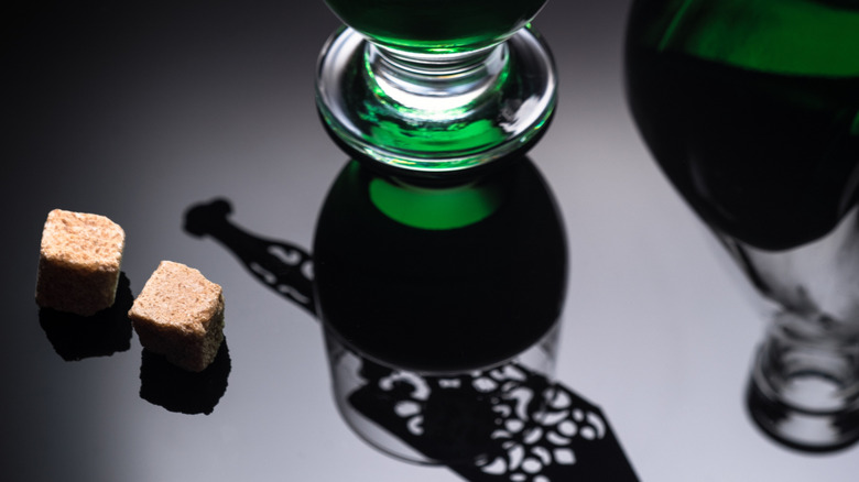 Glass of absinthe with a slotted spoon and a sugar cube