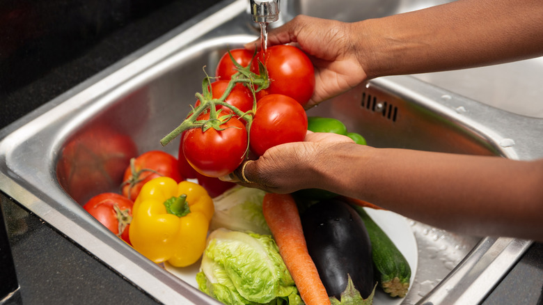 veggies washed under faucet