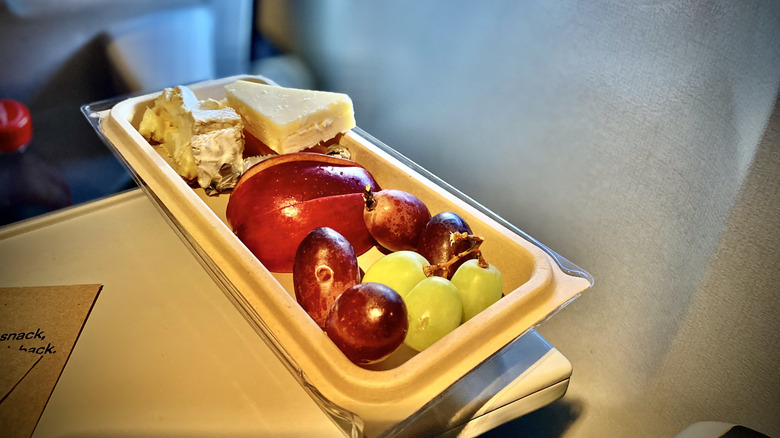 Fruit and cheese in a disposable tray during a flight