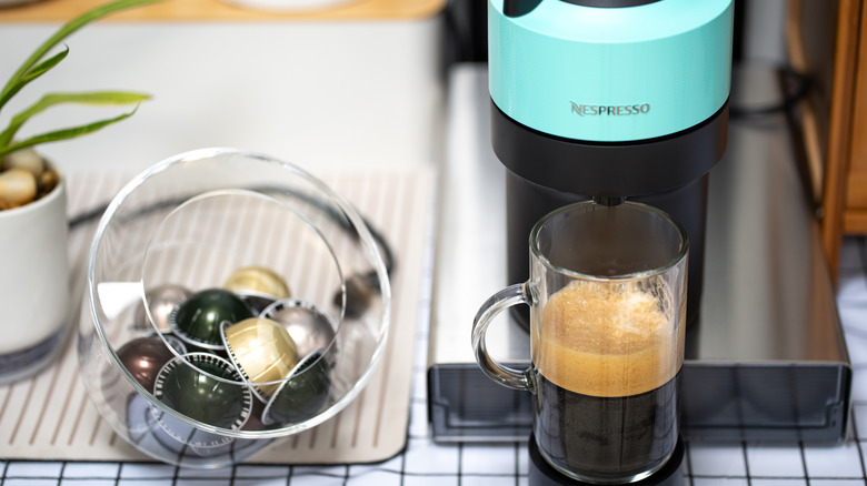 A nespresso machine with a cup underneath.