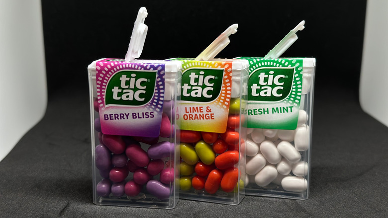 Three multi-colored Tic Tac containers