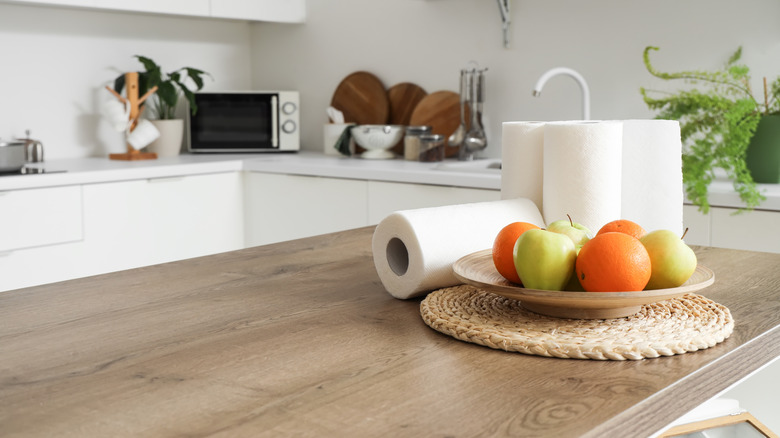 Rolls of paper towel sitting on a counter.