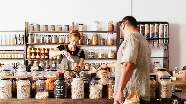 Worker and shopper in zero-waste store