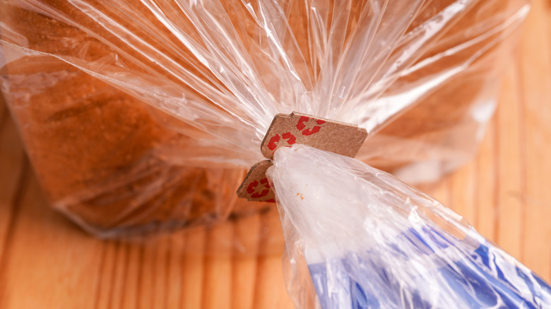 A bread tag sealing a plastic packet around a loaf of bread