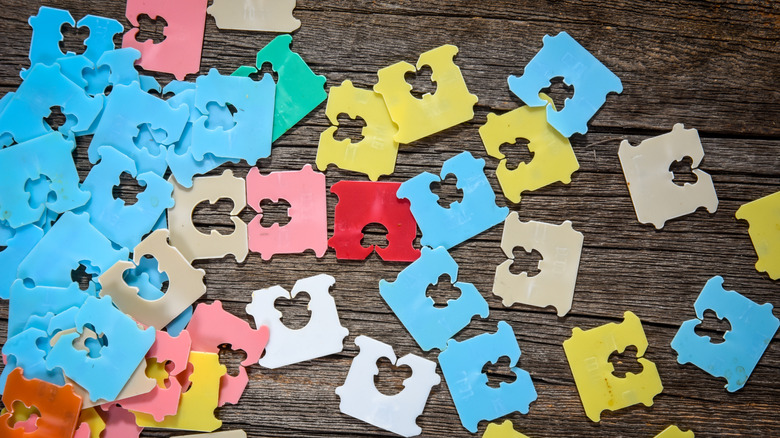 Colorful bread bag tags on a wooden surface