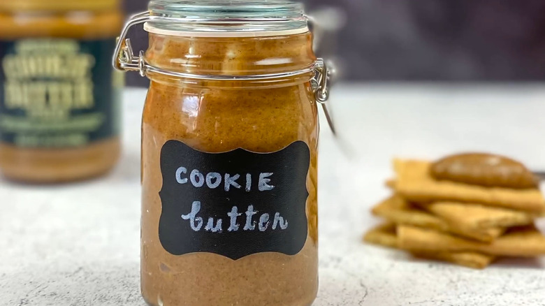 Jar of homemade cookie butter next to graham crackers