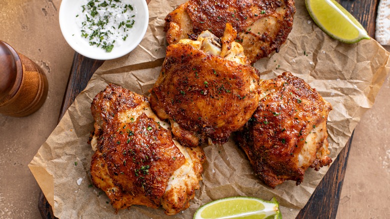 cooked chicken thighs on parchment paper