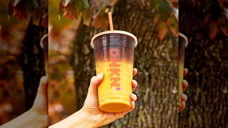 Person holding Dunkin' Peanut Butter Cup Macchiato