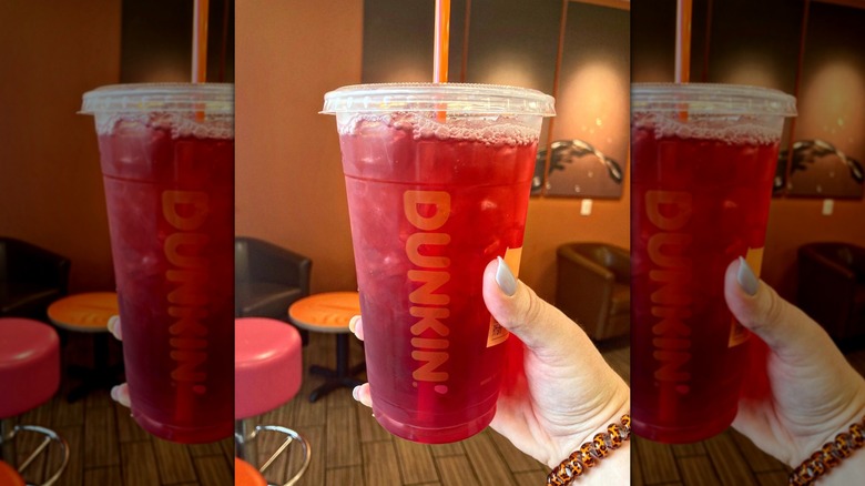 Person holding Dunkin' Raspberry Watermelon Refresher