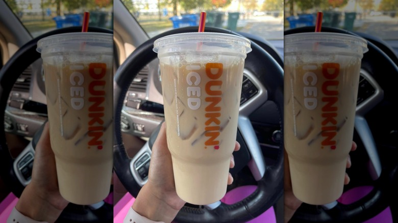 Person holding Dunkin' Vanilla Chai Latte