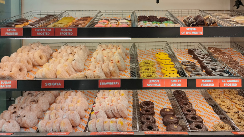 dunkin donut racks with many varieties of donut on display