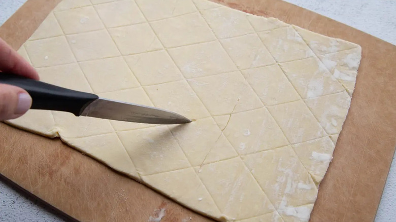 Knife scoring puff pastry sheet