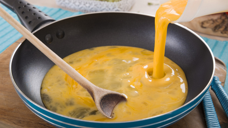 Liquid egg being poured into pan