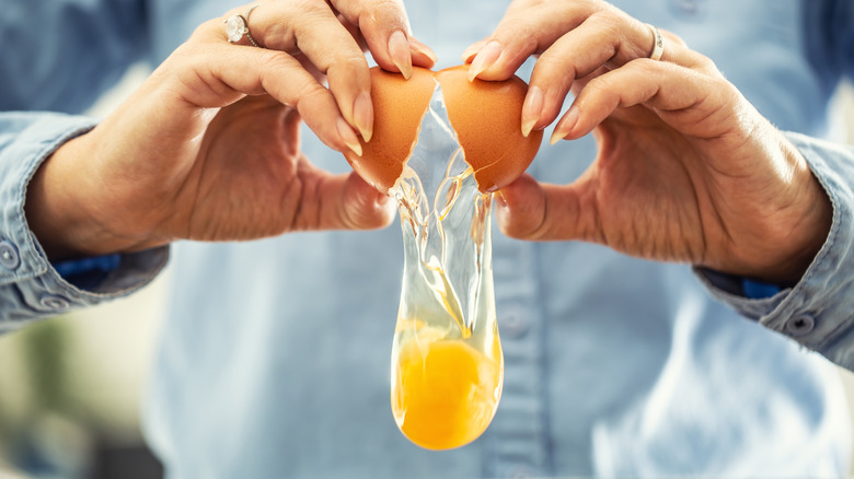 Person cracking an egg