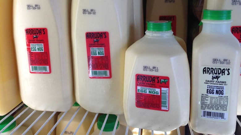 Various sized bottles of Arruda's eggnog in a refrigerator