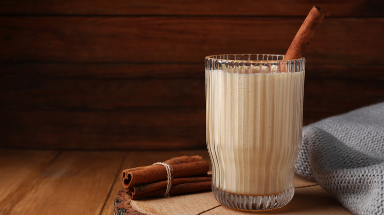 Glass of eggnog with cinnamon stick