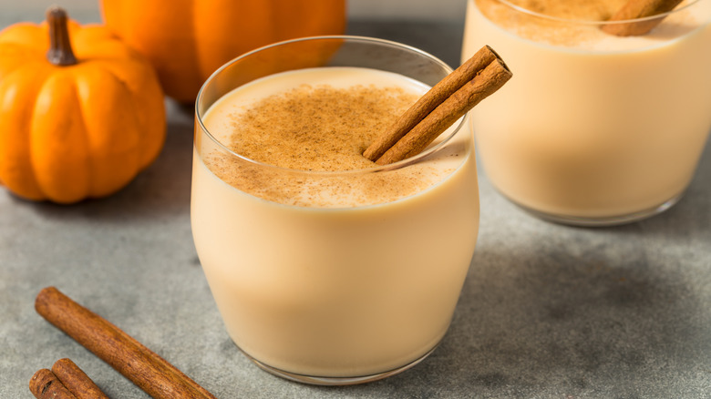 Glass of eggnog with cinnamon stick