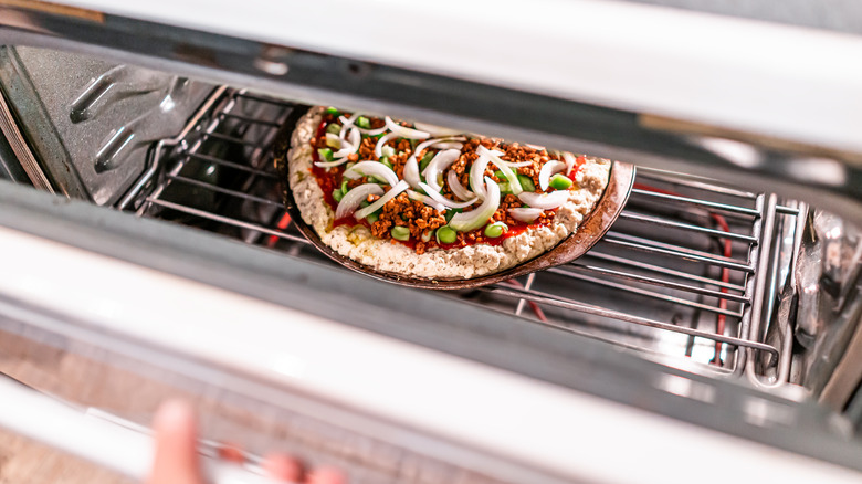 A frozen pizza in an oven